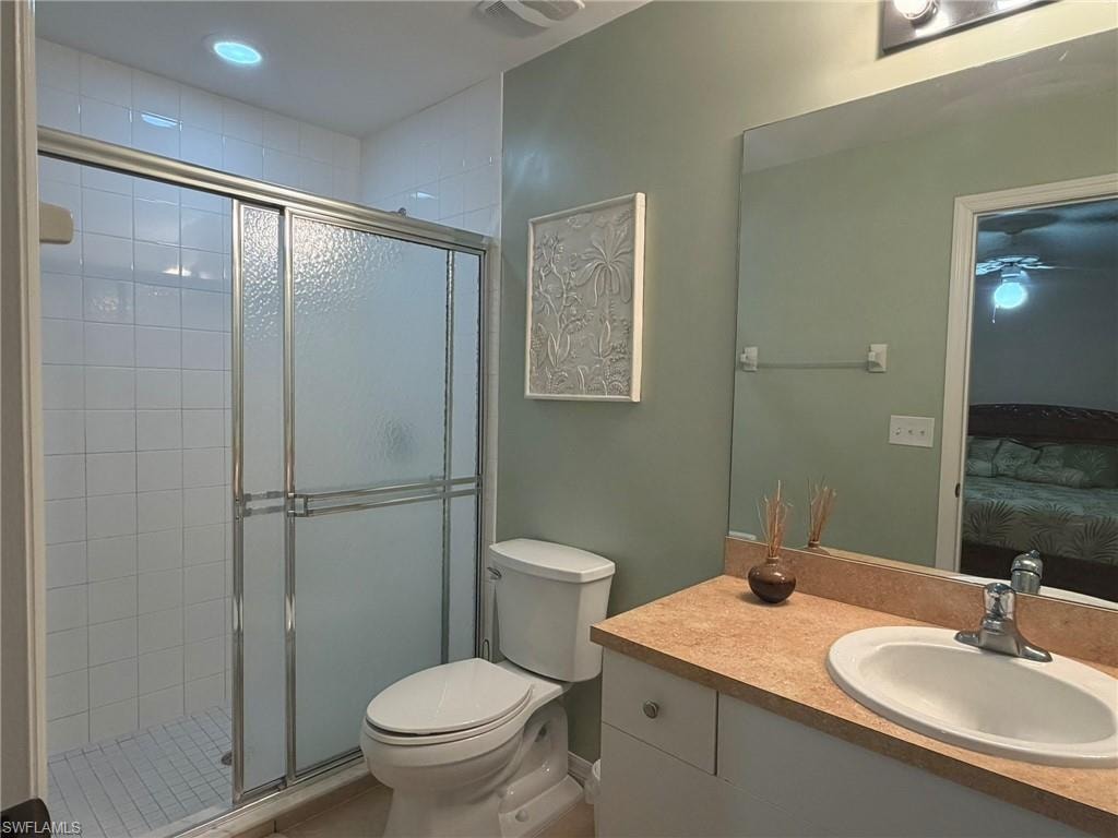 Full bath with connected bathroom, vanity, and a shower stall