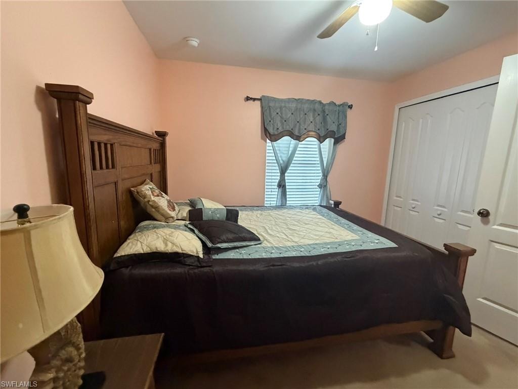 Bedroom featuring ceiling fan and a closet
