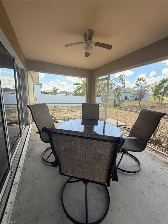 View of patio featuring outdoor dining area and a ceiling fan