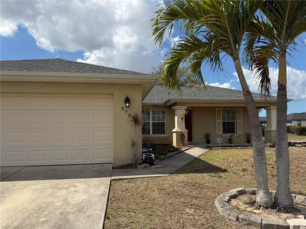 Ranch-style house with stucco siding, roof with shingles, concrete driveway, an attached garage, and a porch