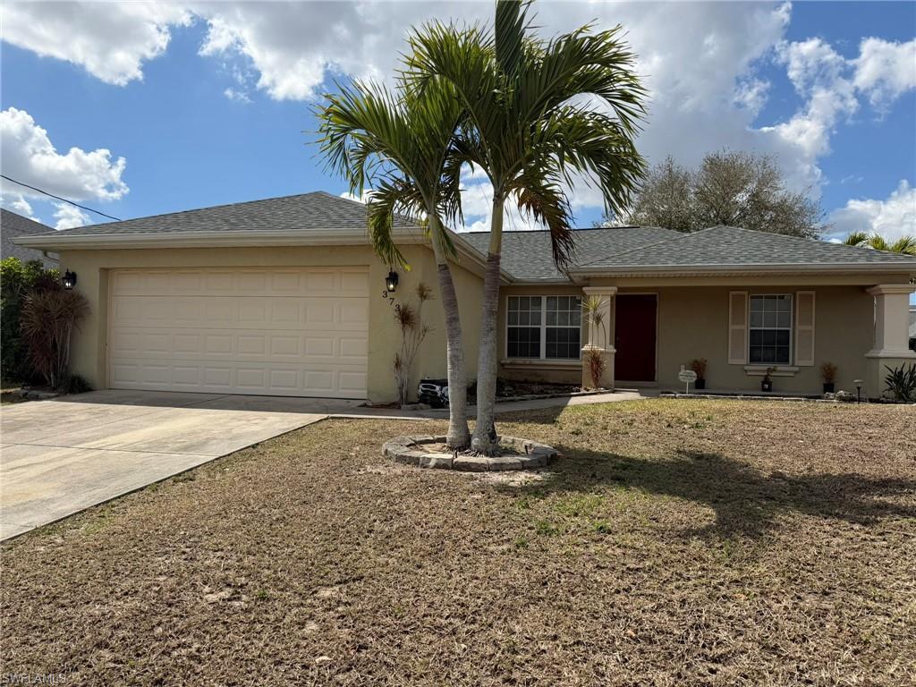 Ranch-style house featuring stucco siding, a garage, concrete driveway, and roof with shingles