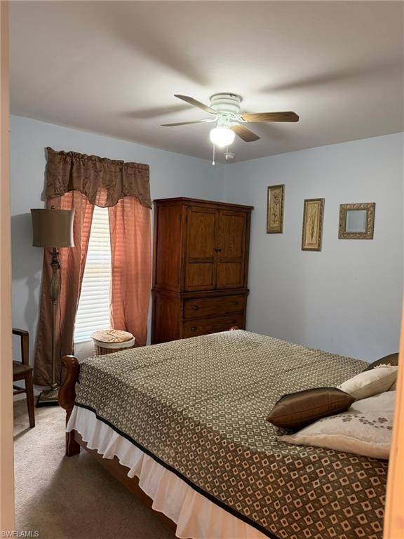 Carpeted bedroom featuring ceiling fan