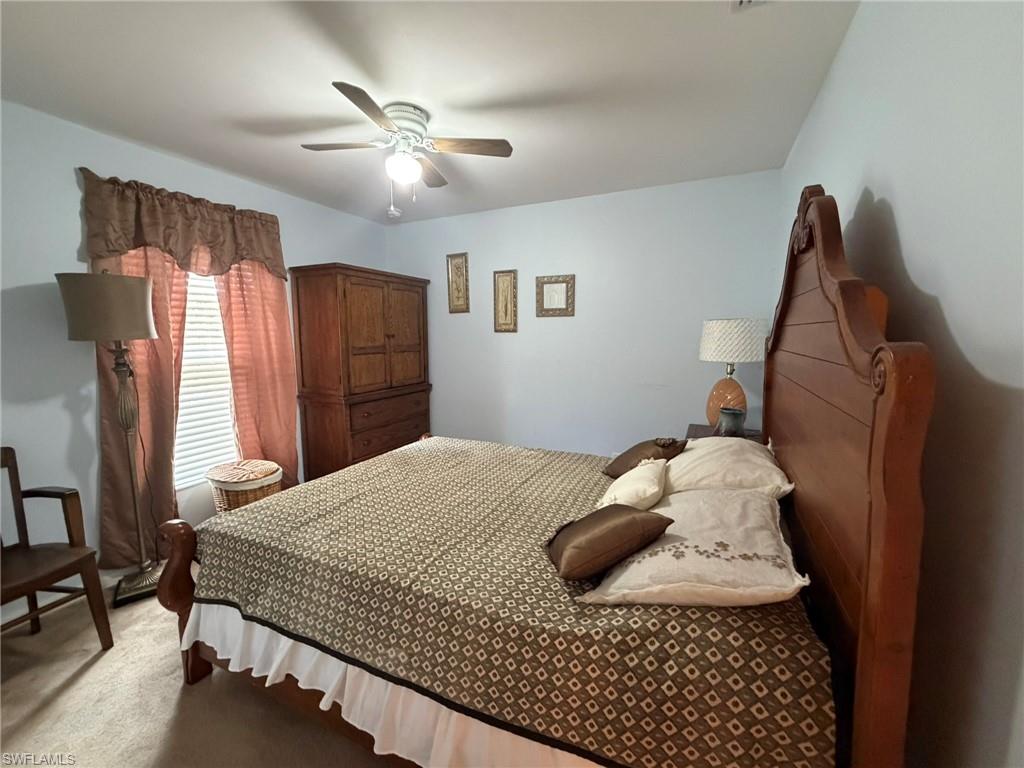 Bedroom featuring ceiling fan and carpet floors