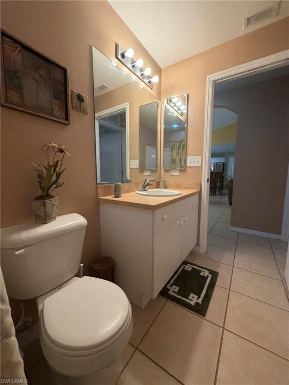 Half bath with light tile patterned flooring and vanity