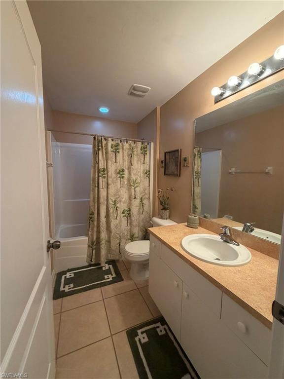 Full bathroom with vanity, shower / bath combination with curtain, and light tile patterned floors