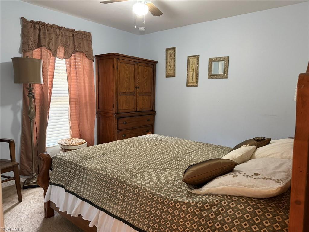 Bedroom featuring light carpet and ceiling fan