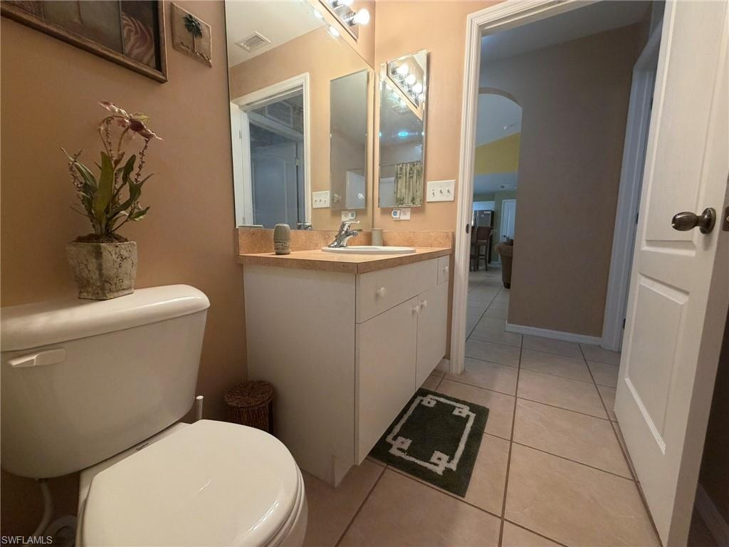 Bathroom featuring light tile patterned floors and vanity
