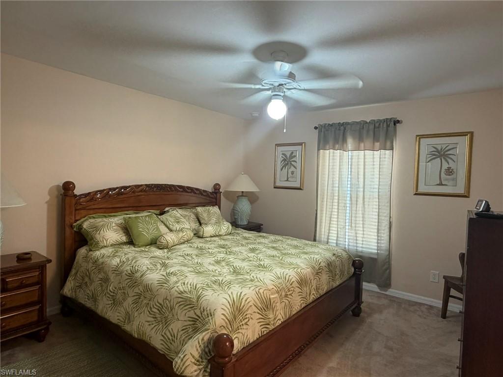 Bedroom featuring dark carpet and ceiling fan