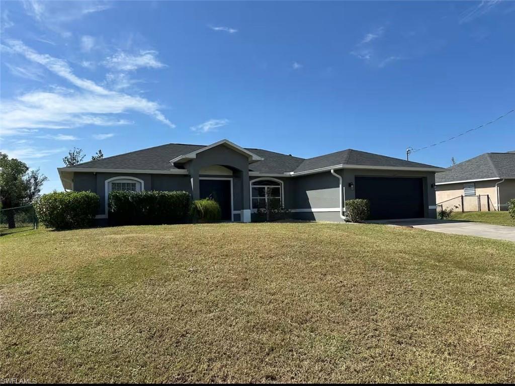 Single story home featuring stucco siding, driveway, and an attached garage
