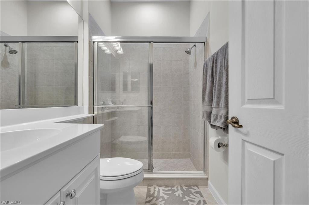 Full bathroom with vanity and a shower stall