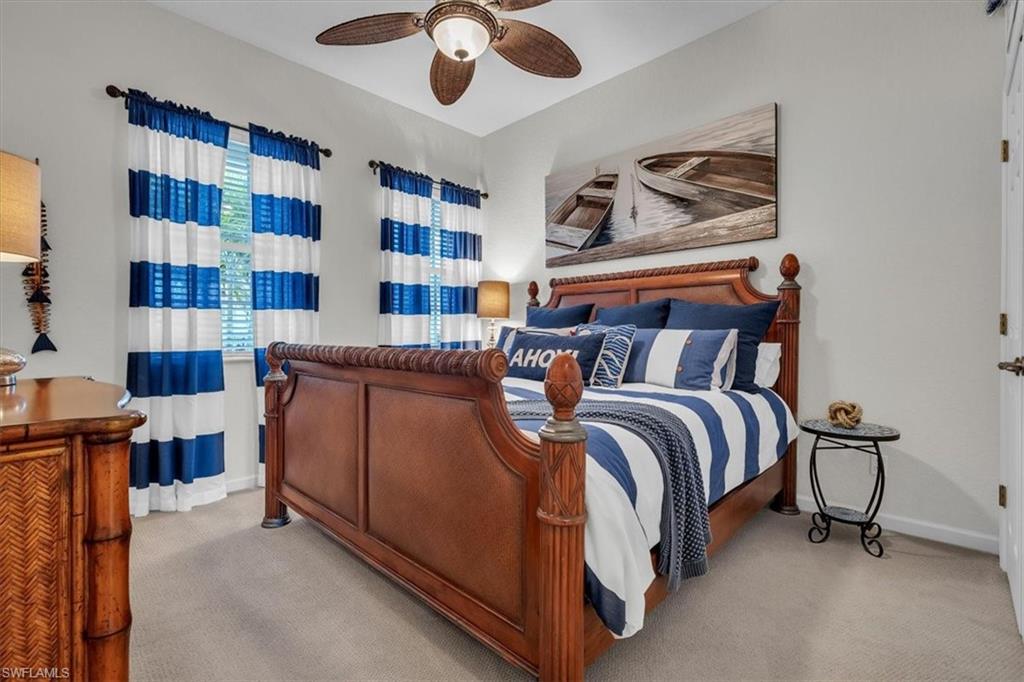 Bedroom featuring a ceiling fan and light colored carpet