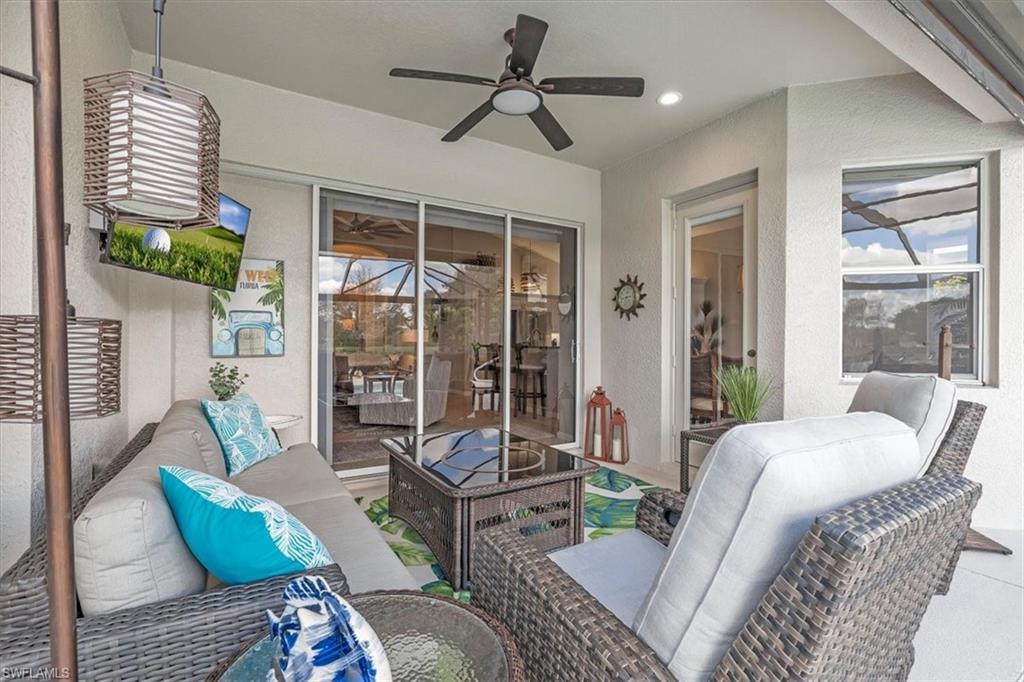 View of patio with a ceiling fan and outdoor seating