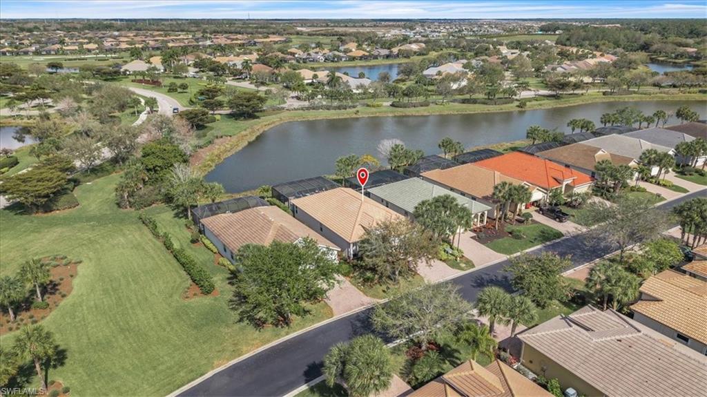 Aerial perspective of suburban area featuring a large body of water