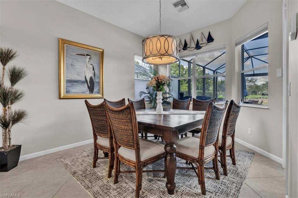 Dining space with baseboards and light tile patterned floors