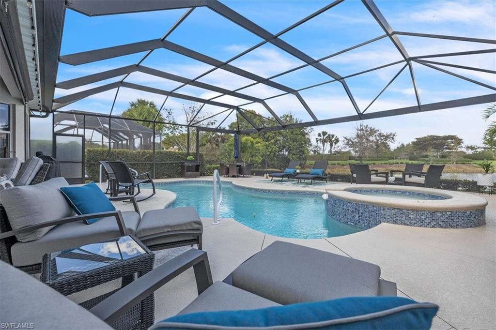 Integrated pool / spa featuring a sunroom, a patio, a lanai, and an outdoor lounge area