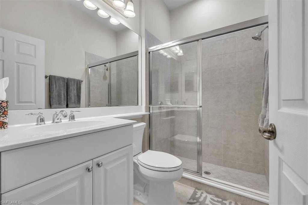 Full bathroom featuring vanity and a shower stall