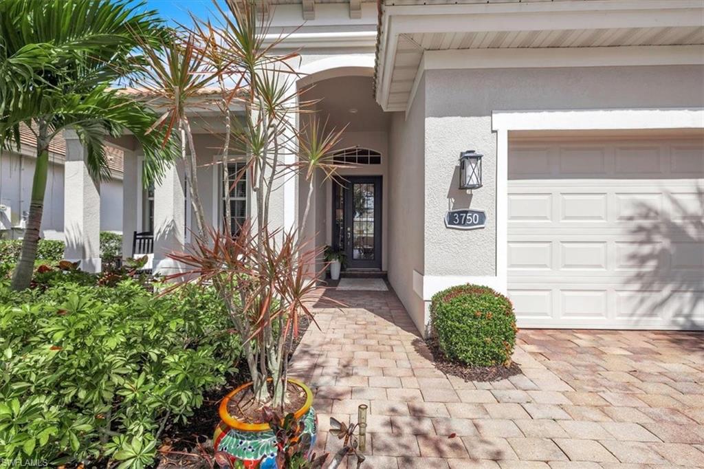 Property entrance featuring stucco siding and a garage