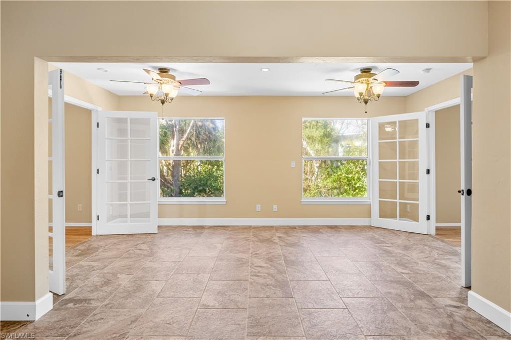 Empty room featuring a ceiling fan and recessed lighting
