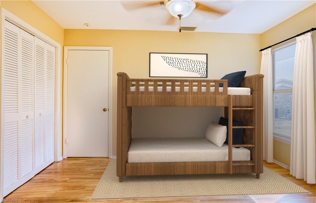Bedroom featuring light wood finished floors, a ceiling fan, and a closet