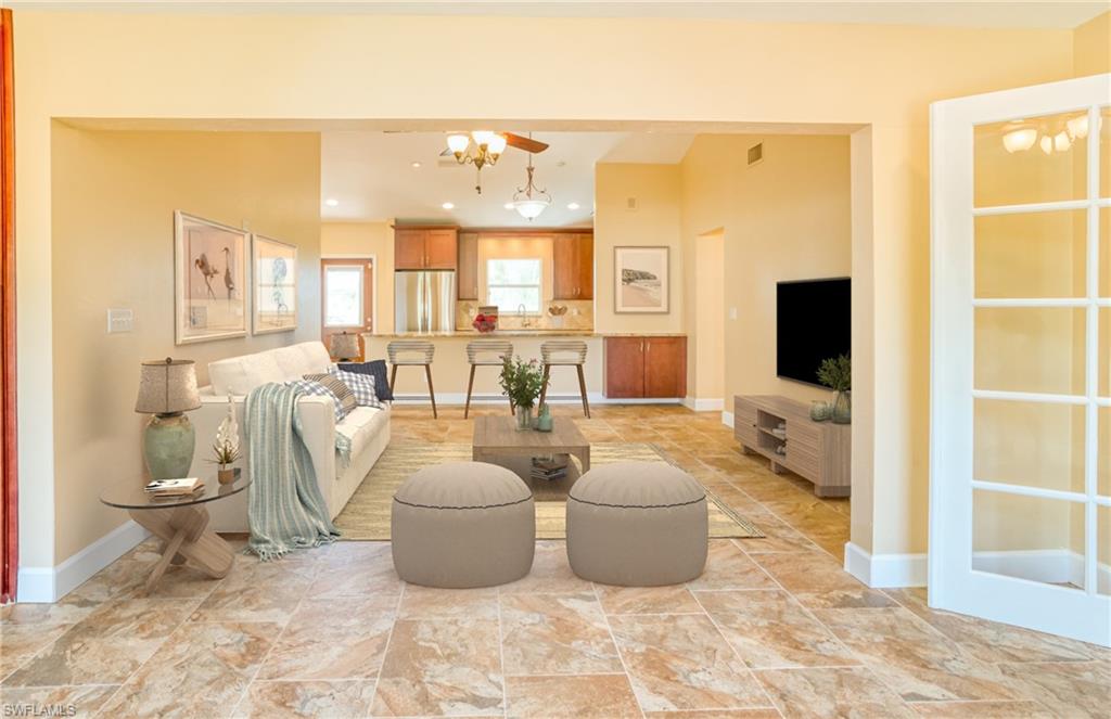 Living room featuring ceiling fan and recessed lighting