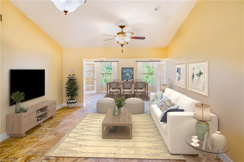 Living room with vaulted ceiling and a ceiling fan