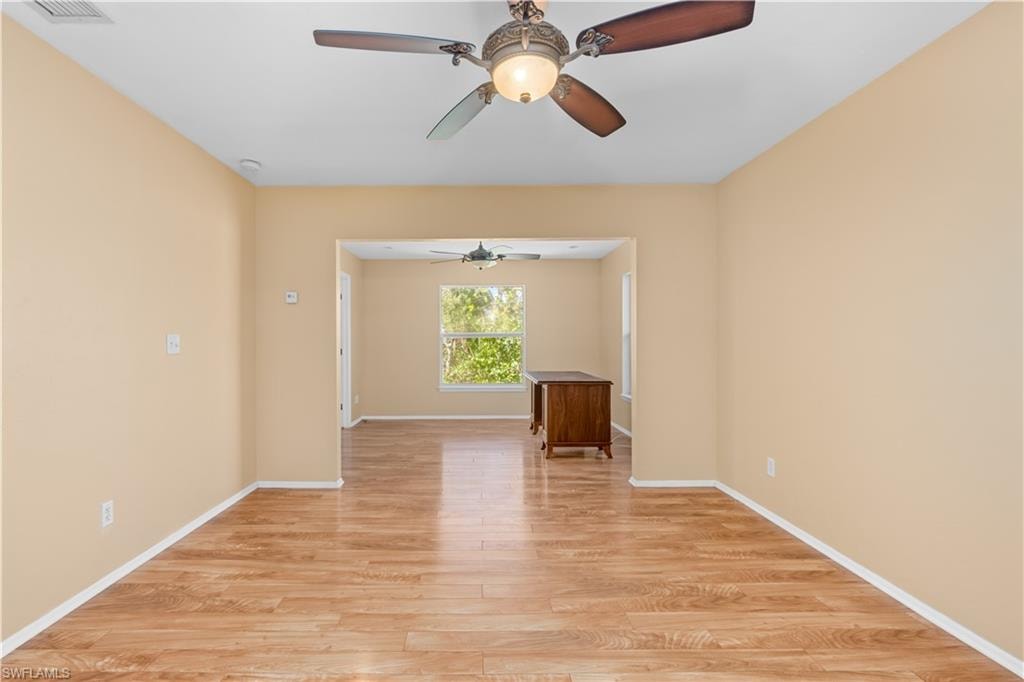 Spare room featuring light wood-type flooring and a ceiling fan