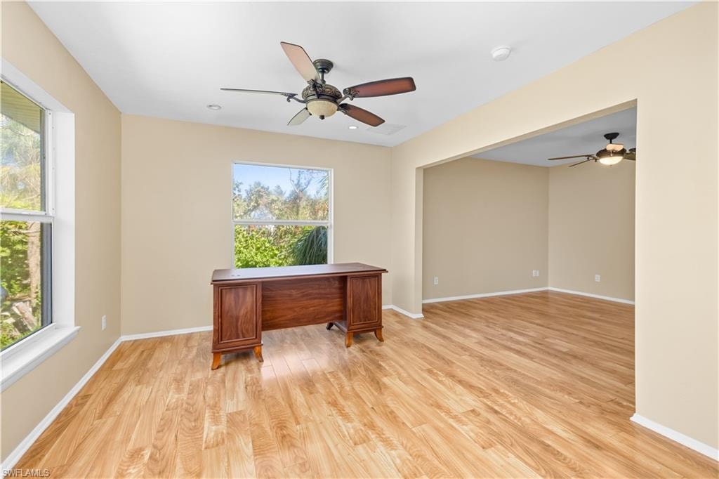Unfurnished office with ceiling fan and light wood finished floors