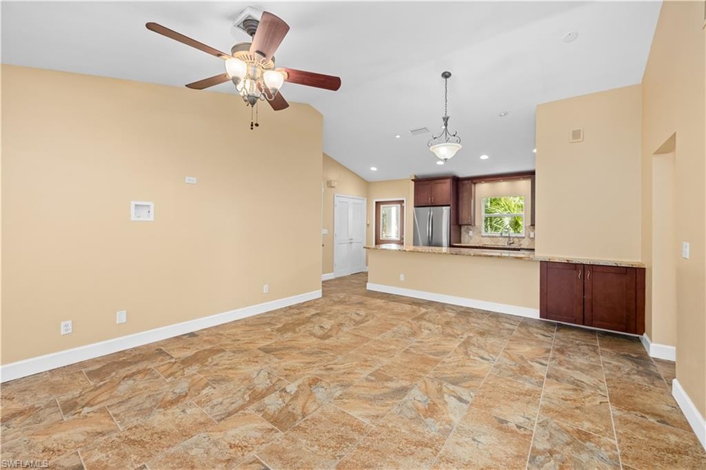 Unfurnished living room with a ceiling fan, lofted ceiling, and recessed lighting