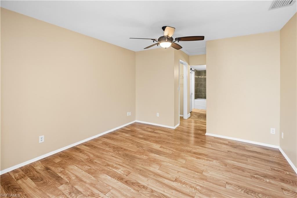 Spare room with light wood-style floors and a ceiling fan