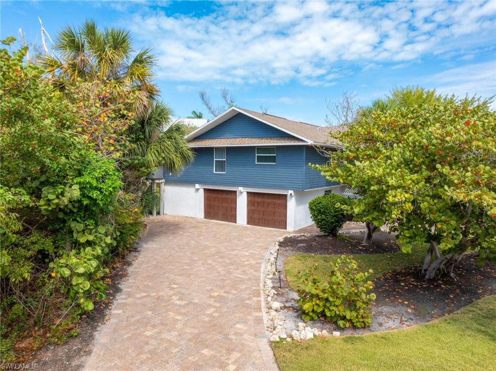 View of home's exterior featuring decorative driveway and an attached garage