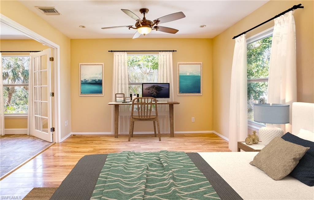 Bedroom with light wood-style flooring, multiple windows, and ceiling fan