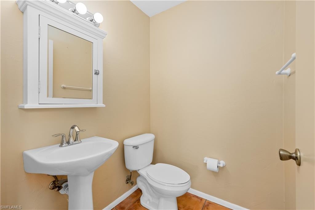 Bathroom featuring toilet and baseboards