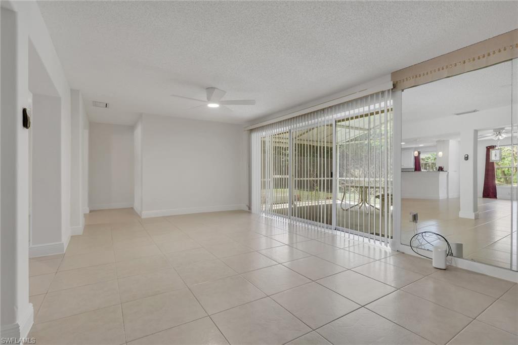 Spare room with a ceiling fan, light tile patterned floors, and a textured ceiling
