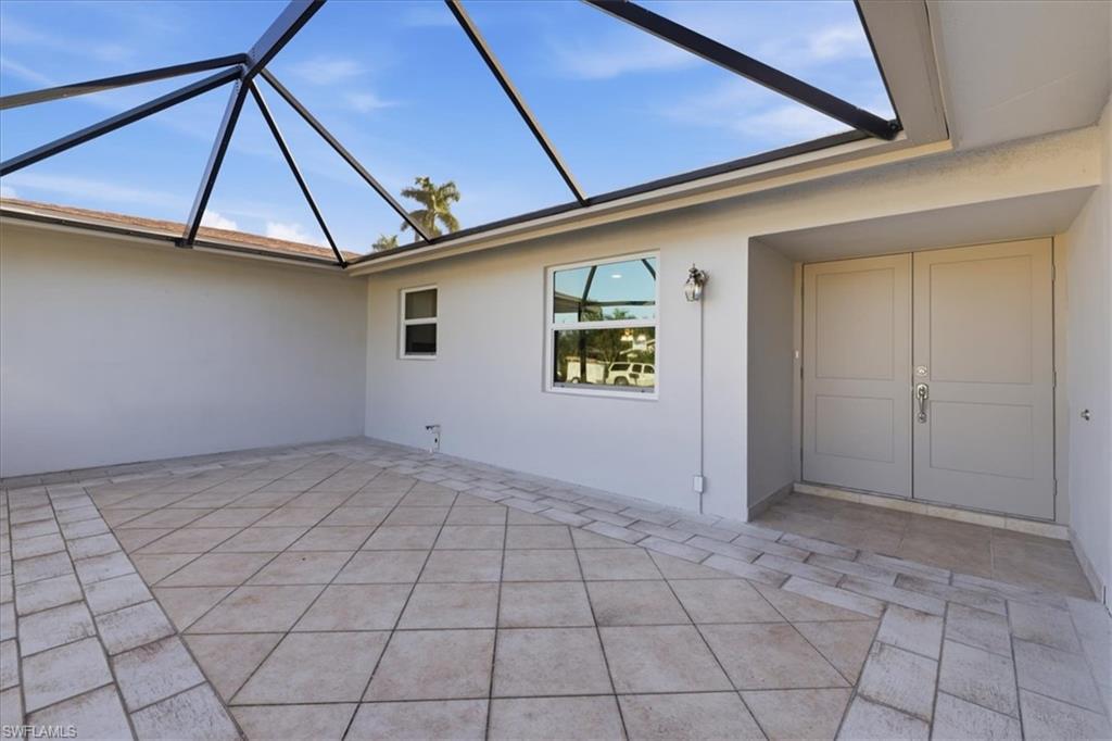 View of patio featuring a screened lanai