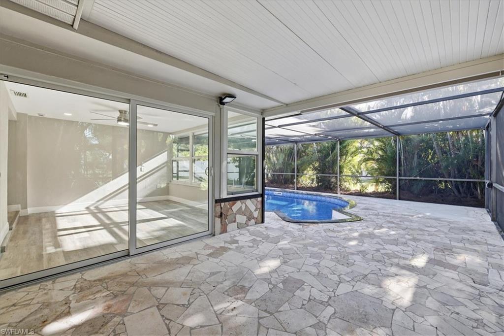 old Outdoor pool with a sunroom, a lanai, and a patio area