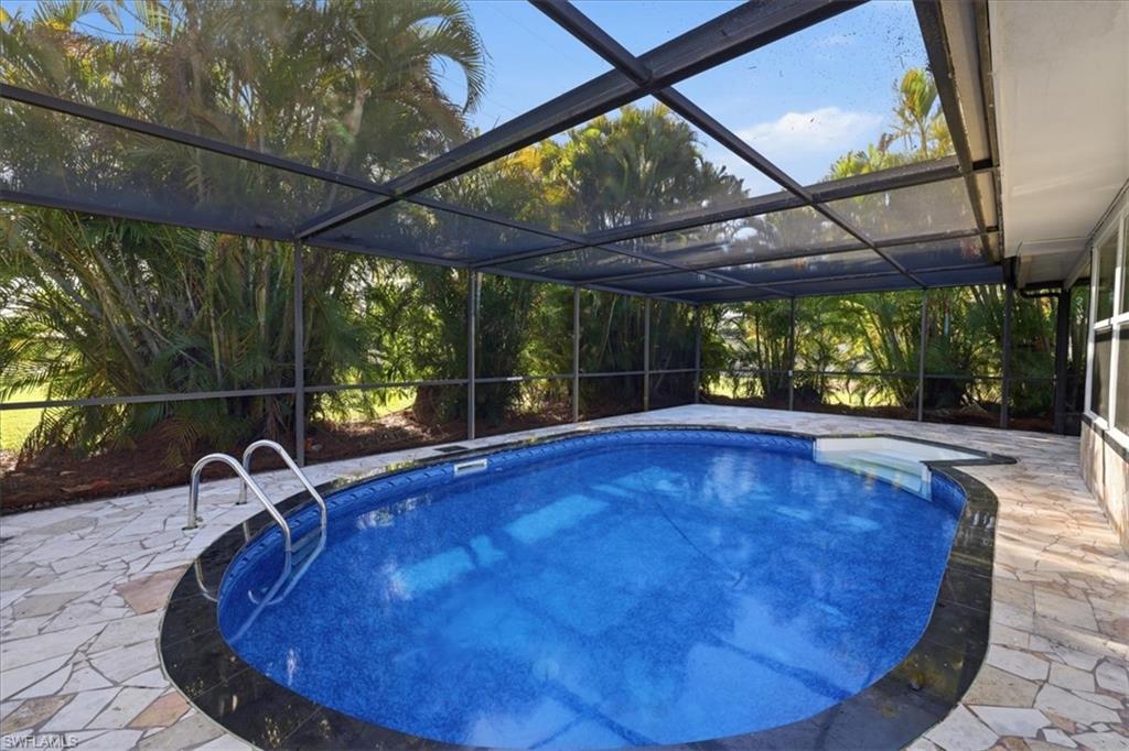 old Outdoor pool with a patio, a sunroom, and a lanai