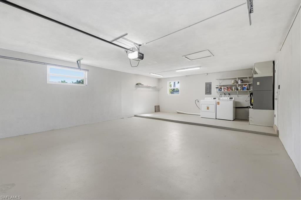 Garage with heating unit, washer and dryer, and electric panel