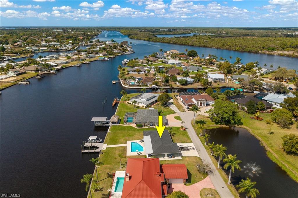 Aerial perspective of suburban area featuring a large body of water