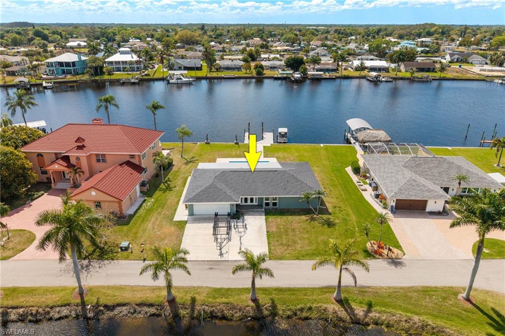 Aerial perspective of suburban area featuring a large body of water