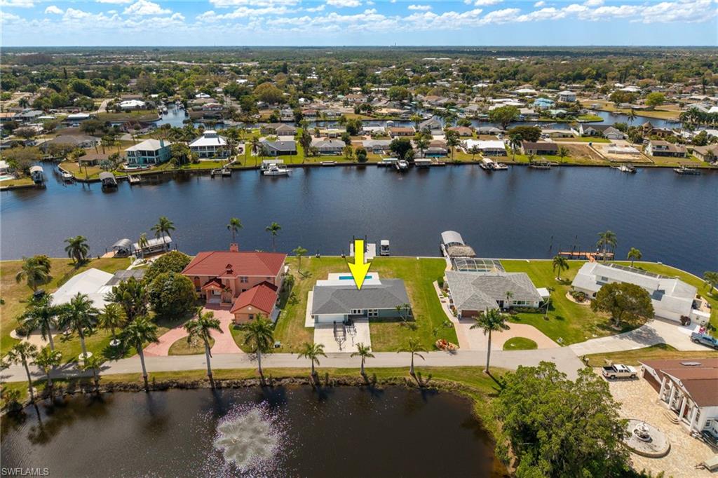 Aerial view of residential area featuring a nearby body of water