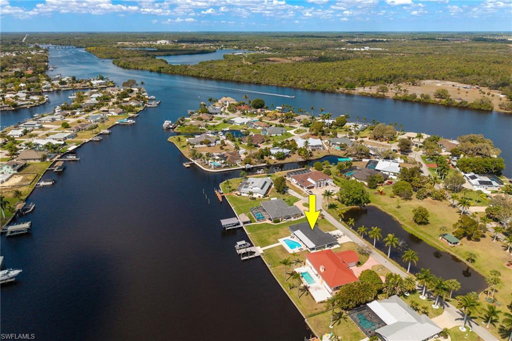 Aerial perspective of suburban area featuring a nearby body of water