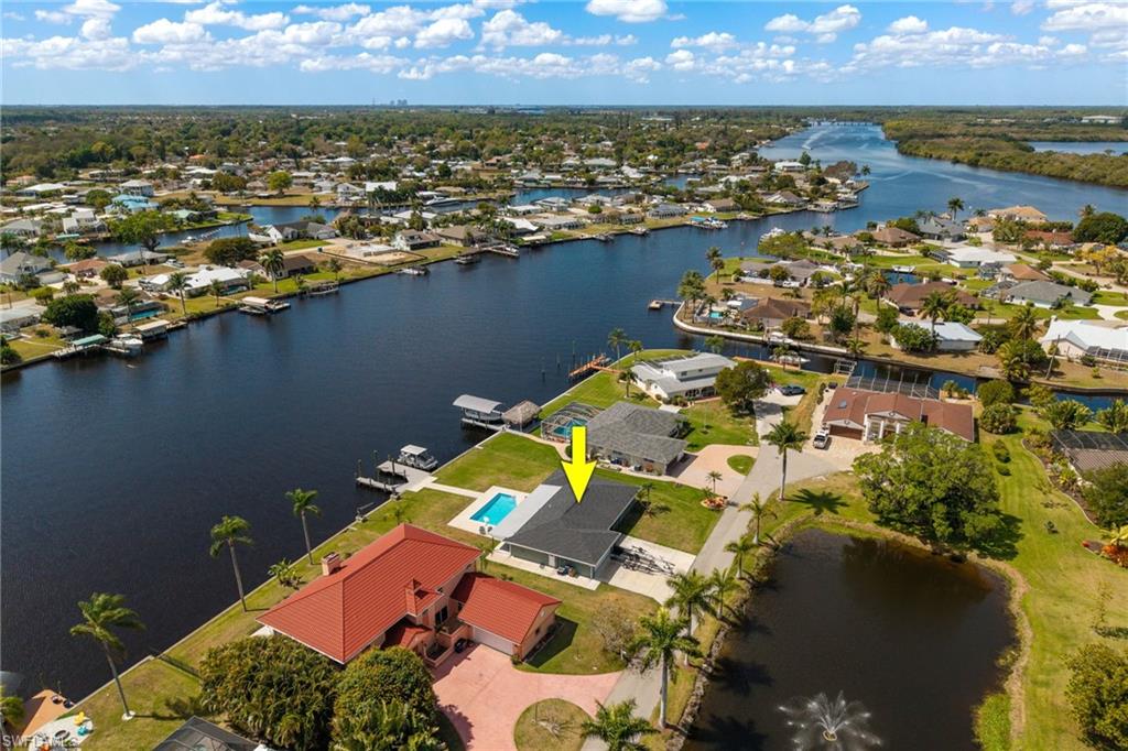 Aerial perspective of suburban area featuring a large body of water