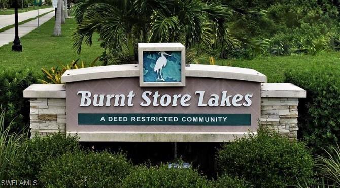 Community / neighborhood sign featuring a yard