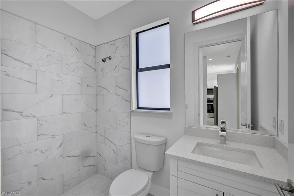 Full bath featuring vanity and a shower stall