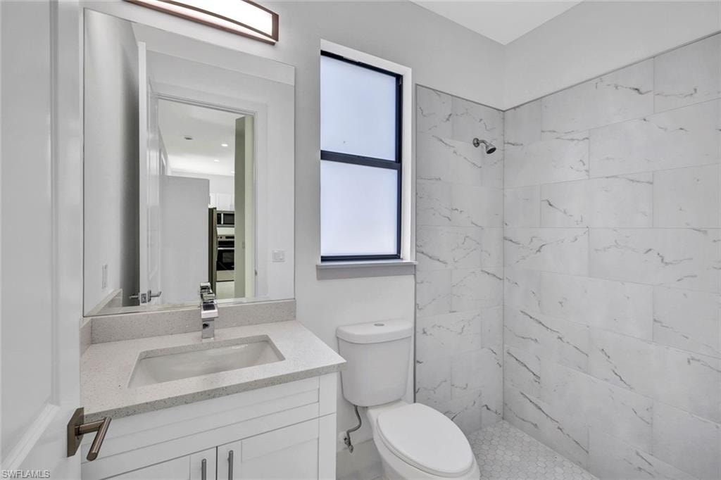 Full bath featuring vanity and a stall shower