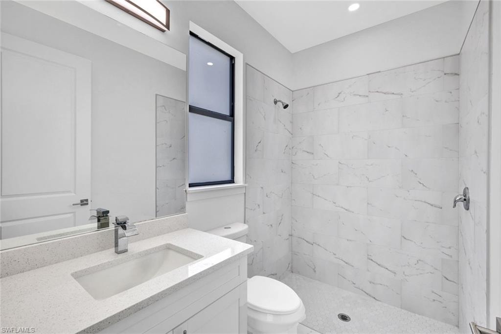 Bathroom featuring a shower stall and vanity