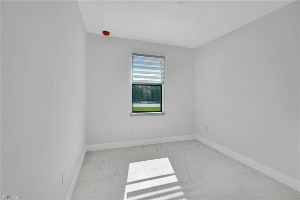 Empty room with baseboards and light marble finish flooring