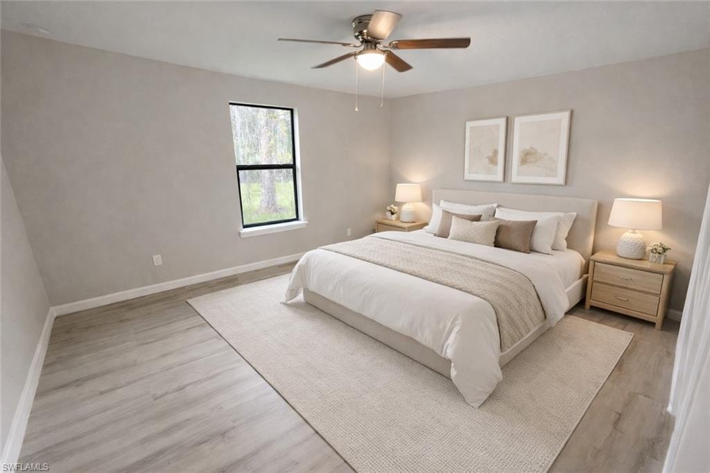 Bedroom featuring a ceiling fan and light wood-type flooring