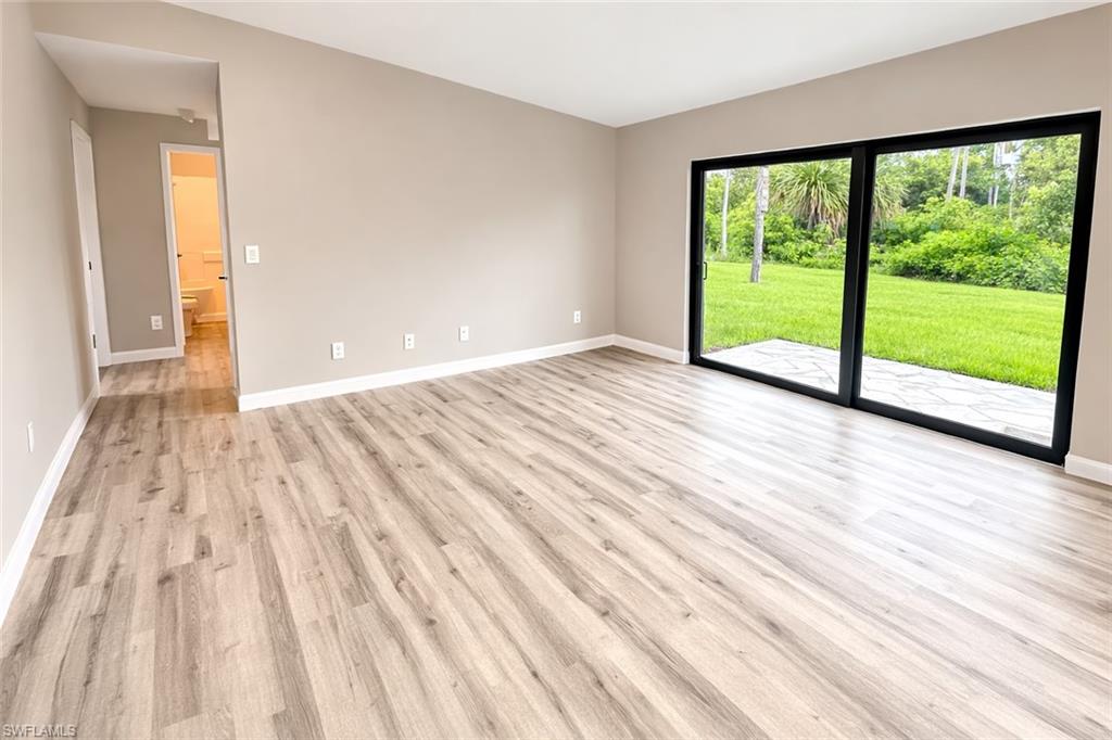 Unfurnished room featuring baseboards and light wood-style floors