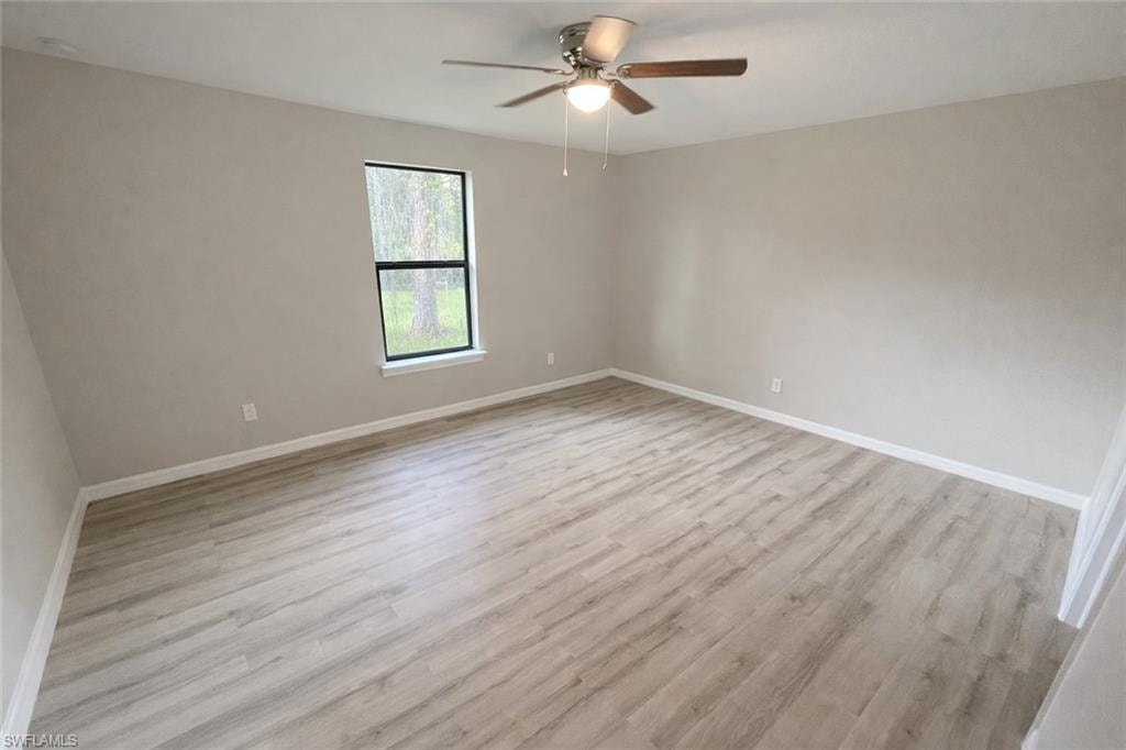Unfurnished room with light wood-type flooring and ceiling fan